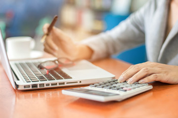 Close up of business woman hands typing on laptop computer in the office.