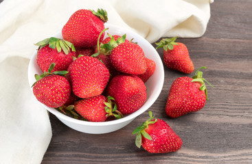 Red strawberries in white bowl