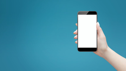 Female hand holding black modern smartphone with isolated screen on blue background