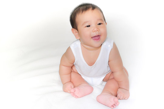 portrait of asian baby isolated on the bed