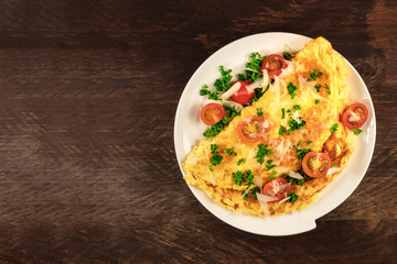 Omelette with parsley, cherry tomatoes, and copyspace