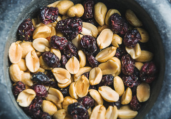 peanuts and raisins mix close up for healthy snack or breakfast.