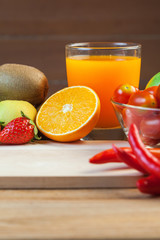 Healthy concept with mixed fruits and vegetables on wooden background