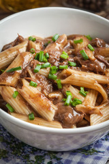 Pasta penne with pork sauce.