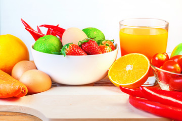 Healthy concept with mixed fruits and vegetables on wooden background