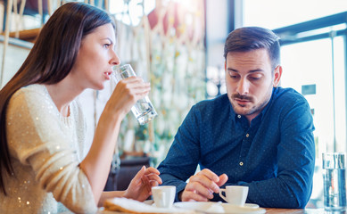 Romantic loving couple drinking coffee, having a date in the cafe. Dating, love, relationships