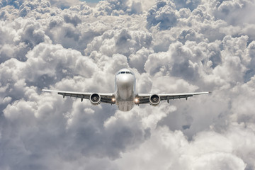 front view of a big jet plane flying through the clouds