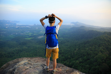 Obraz premium successful woman hiker enjoy the view hiking on mountain peak
