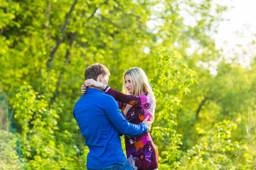 beautiful young love couple hugging in the park