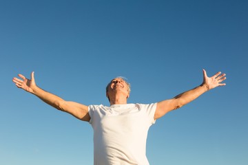 Low angle view of man with arms outstretched
