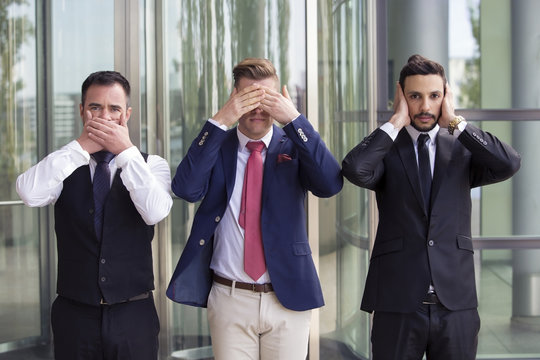 handsome businessmen as the three wise monkeys