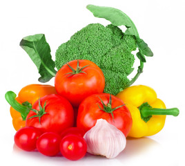 vitamin set of vegetables from the  large broccoli green leaves red ripe tomatoes, orange and yellow peppers and purple garlic with green sprigs of fresh isolated on white background