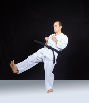 Blow leg athlete is beating on a black background