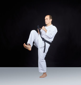 Sportsman is beating blow knee in karategi