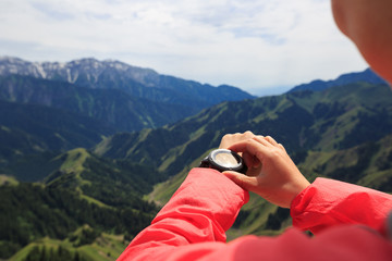 Woman hiker checking the altimeter