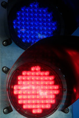 traffic light glowing of the different colors of red and blue in black steel mechanism