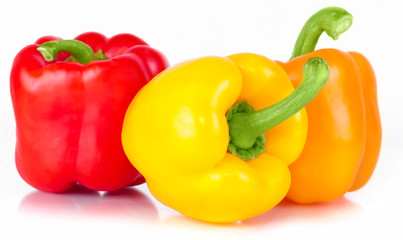.pepper three sweet red, orange, and yellow with bright green стрволом with white light and the water drops diet pepper, isolated on white background