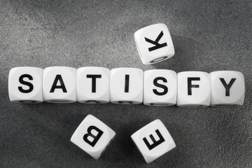 Obraz premium word satisfy on toy cubes