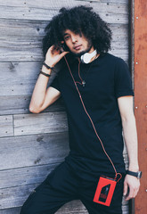 Close up portrait African American man with an afro hairstyle listens to music as DJ, resting....