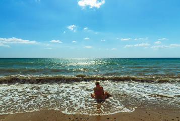 Woman sitting on the beach.