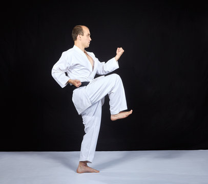 Block by hand and blow leg is training the athlete in karategi