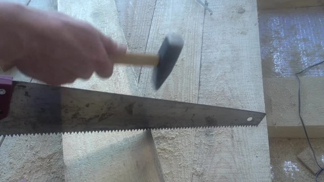 the Builder has a hammer on the hacksaw,an example of how not to work.