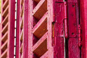 Old wooden shutters in red color