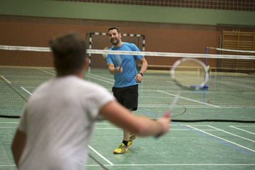 young man playing badminton