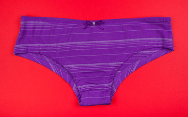 Women's cotton panties flowered isolated on red background.