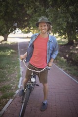 Portrait of smiling man with bicycle