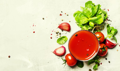 Tomato juice with green basil and spices, top view, food background