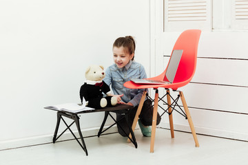 Fototapeta premium Happy pretty girl smiling to teddy bear toy