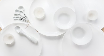 Empty white plates of different sizes for the whole background
