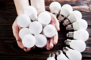 A girl is holding a lamp. Hands close-up.