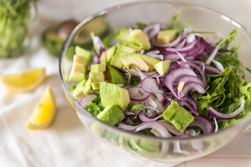 Racy salad with chickpea, arugula, pearl barley, onion and avocado 