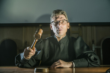 a judge with a hammer in his hand in the court room