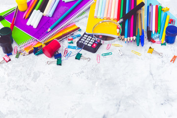 School supplies: colored pencils wooden yardstick erasers binders stationery gum paper clips pencil sharpener a small clothespin colored pins pencil and pen isolated on white background