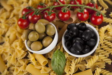 Dry pasta with ingredients on a old wood