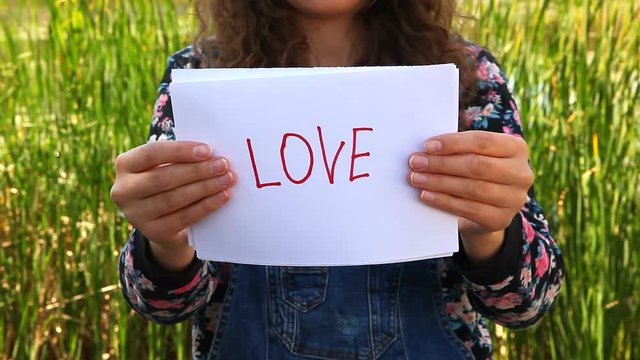 Woman hands shows word Hate, and then Love, relationship concept