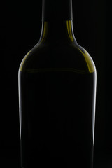 bottle with red wine on black