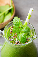 Spinach smoothie, on the grey  background.