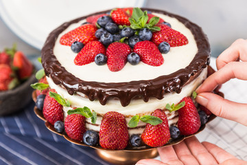 Sour cream cake decorated with berries close up