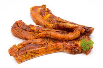 Spicy marinated spare ribs barbecued on the white background.