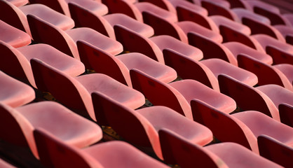 Fototapeta na wymiar Close up red seats of stadium.