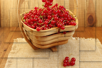 fresh red currant on the wooden vase