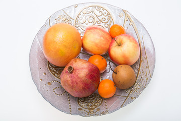 mix fresh fruits on plate isolated on white