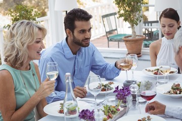 friends interacting with each other while having meal