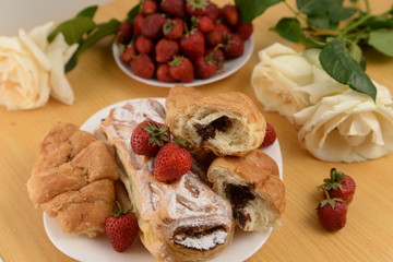 Delicious breakfast with fresh pastry and strawberries 