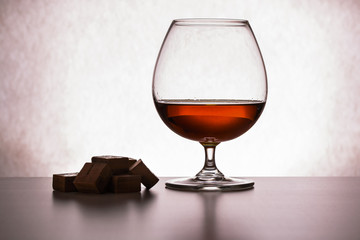 glass of brandy and chocolate pieces