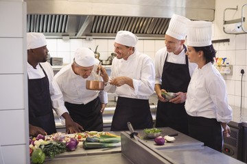 Fototapeta na wymiar Team of chef tasting food in the commercial kitchen